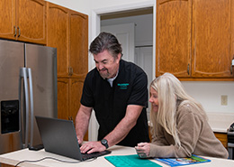 HouseMaster Inspector greeting three people at the front door.