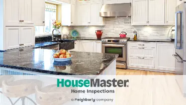 Bright kitchen with HouseMaster logo.
