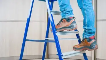 Person standing on a ladder.