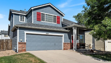 A home with a spacious garage and a driveway providing access to the front door.