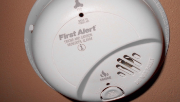 A wall-mounted smoke detector.