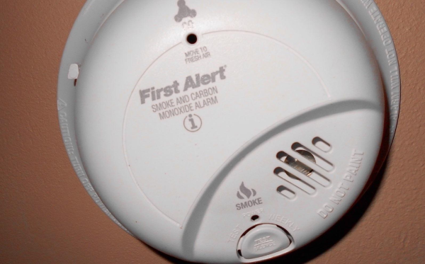 A wall-mounted smoke detector.